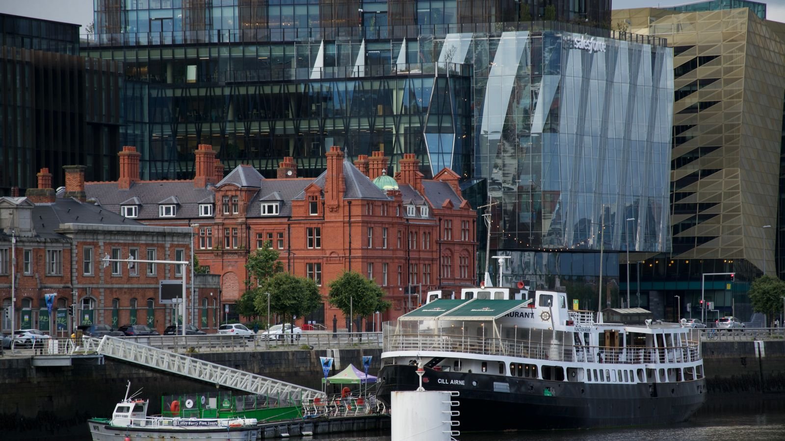 Glass offices beside historic brick warehouses on the Dublin Docklands waterfront