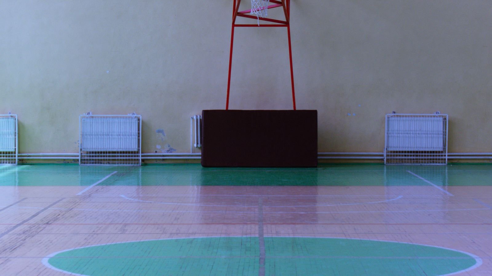 Bright school hall with a full height glazed wall and sprung floor